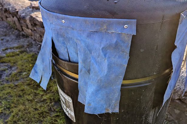 Disbelief as workmen install 'ridiculous' DIY curtains on council litter bins in North Wales town