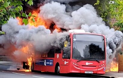 Huge fire rages through bus as smoke pours from windows and 30 firefighters tackle blaze in dramatic footage